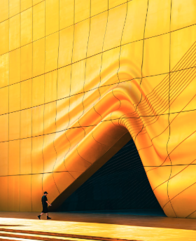A golden facade with a figure for scale