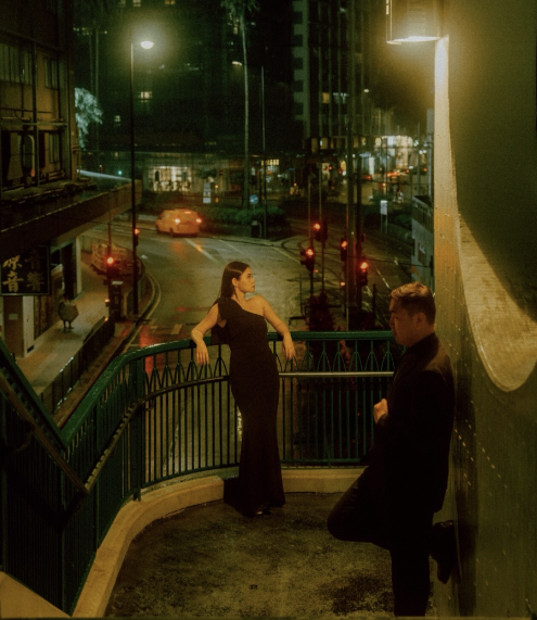 A couple on a stairway at night