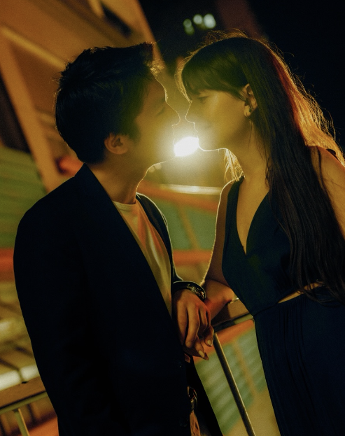 A couple in warm backlight at night
