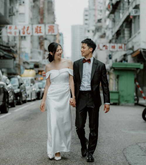 A wedding couple walking through a Hong Kong street