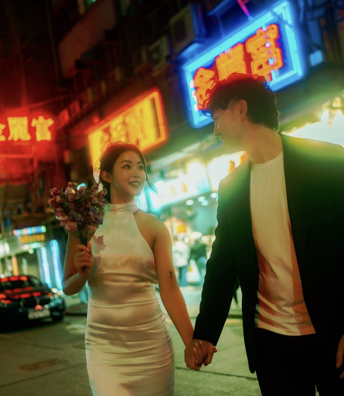 A wedding couple under neon signs